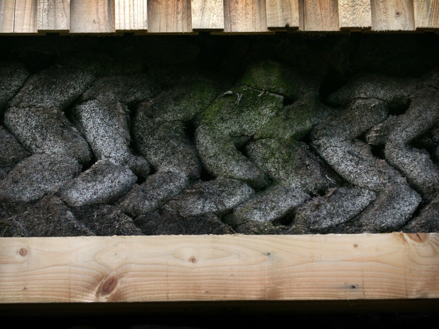 An earth wall, sandwiched between two timber panels