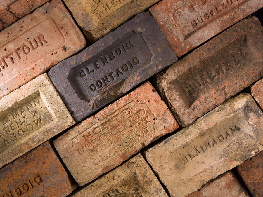 A row of bricks, which are all stamped with the location they were made