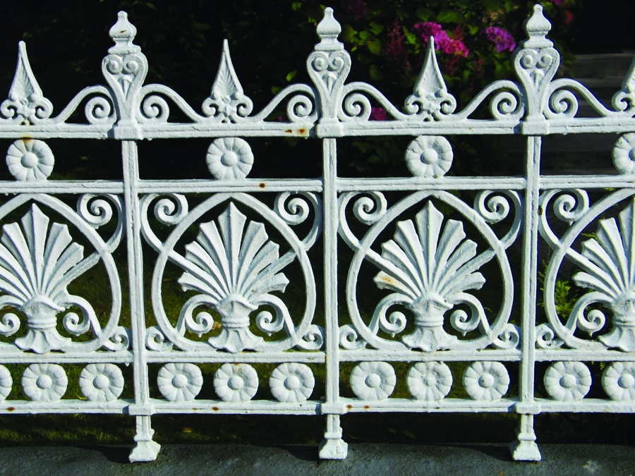 White painted cast iron railings with decorate floral patterns
