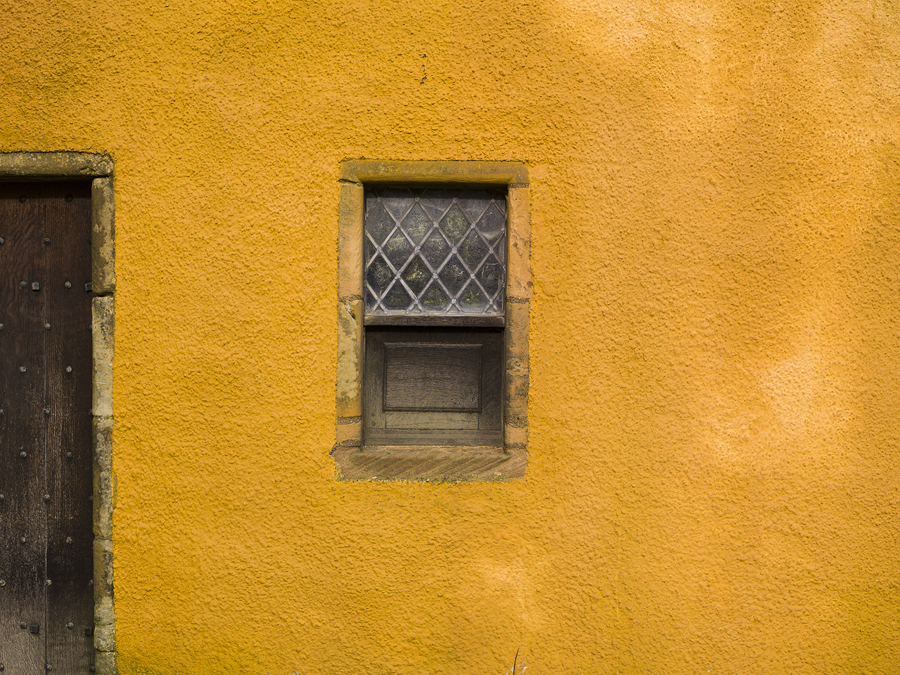 An orange lime harled historic building