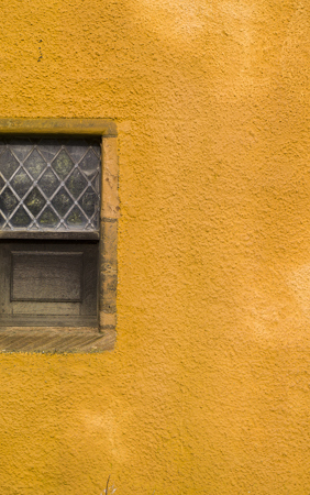 An orange lime harled historic building