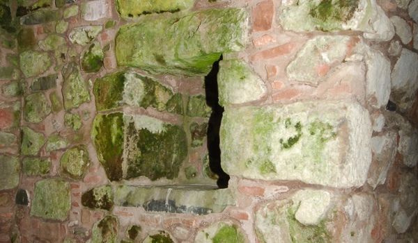 Stone roof interior showing damp and algae growth