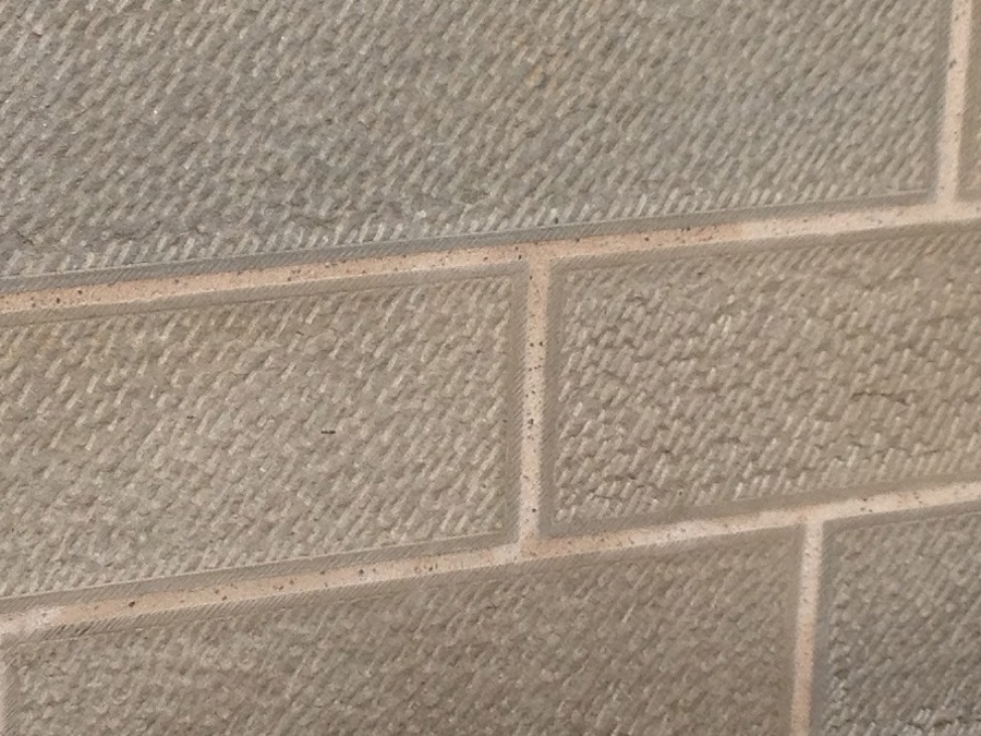 A wall made of uniform, rectangular sandstone blocks joined with mortar