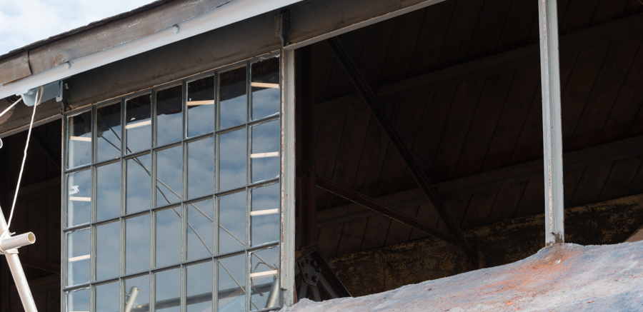 A lead window made up of many panels being reinstalled into the Engine Shed
