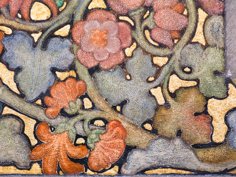 A painted mural with blue, red, purple and pink flowers on it
