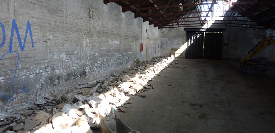 Interior of The Engine Shed during preparation for renovation while rubble gathered along wall