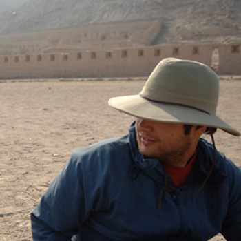 Justin wearing a hat, in a sandy location