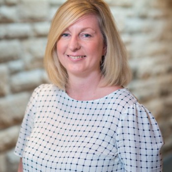 A headshot of Lesley smiling