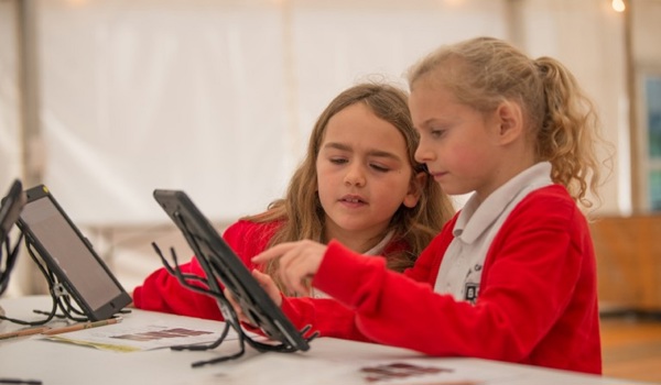 Two schoolchildren learn using ipads