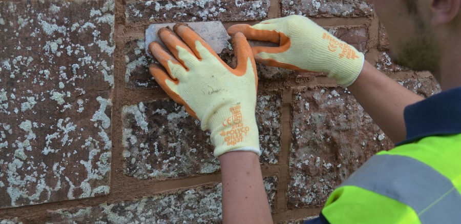 Someone applying mortar to a wall
