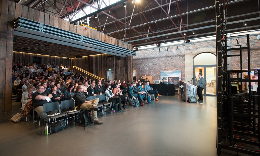 People sitting inside the Engine Shed open auditorium