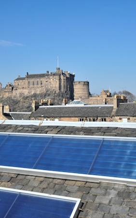 Solar thermal panels on a slate roof, with Edinburgh Castle in the background