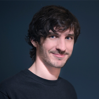 David, who has medium-length dark hair with a fringe, smiling