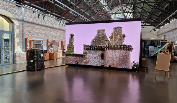 The inside of the Engine Shed, showing a large screen with a castle ruin.