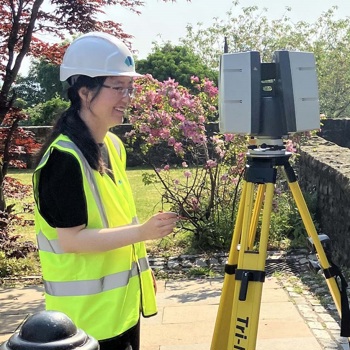 Yueqian Wang is using a 3D scanner in high vis vest and with a hard hat.