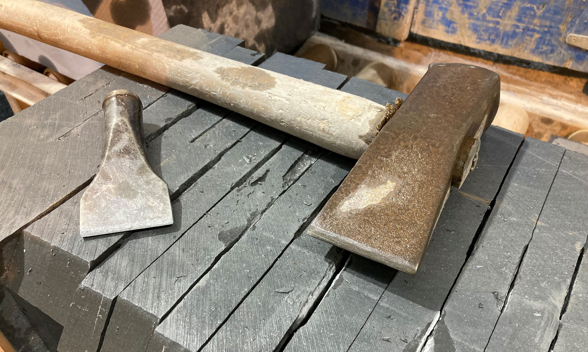 Slate cutting tools sitting on top of a large batch of slate.