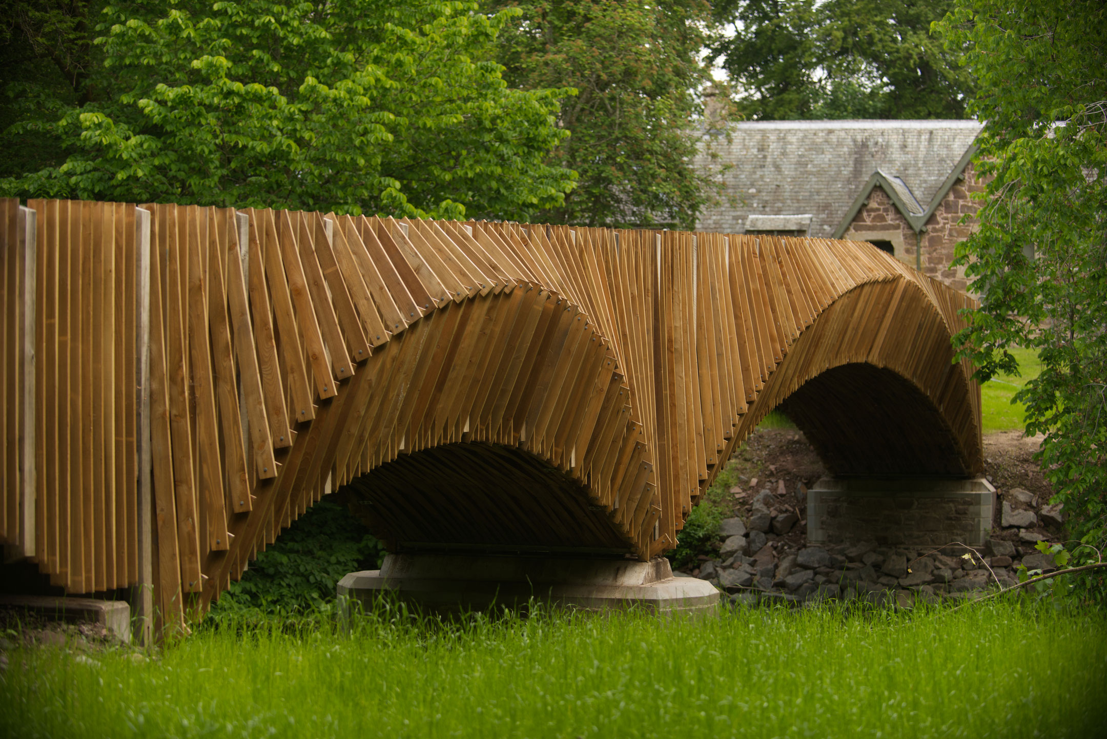 A contemporary larch bridge with striking arched sections.